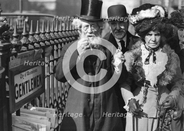 A group of people passing a gents' public toilet, Westminster, London, c1900-1919(?). Artist: Unknown