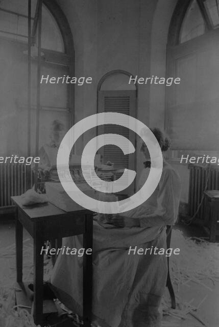 Women trimming and stacking currency sheets at the Bureau of Engraving & Printing, c1890. Creator: Frances Benjamin Johnston.
