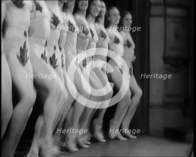 A Troupe of Dancers Wearing Fig Leaf Costumes Synchronised Dancing in Front of an Audience..., 1931. Creator: British Pathe Ltd.