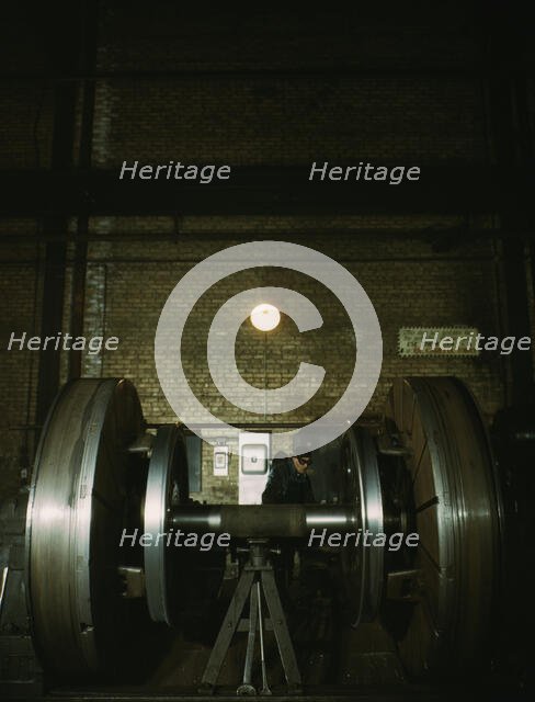Worn tires on locomotive wheels are refaced on this machine in the wheel shop..., Chicago, 1942. Creator: Jack Delano.