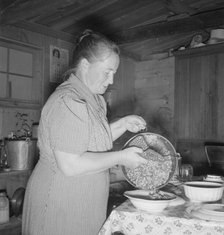 Mrs. Wardlow getting dinner after church in her basement..., Dead Ox Flat, Oregon, 1939. Creator: Dorothea Lange.