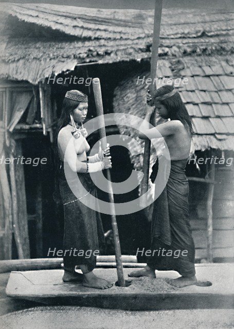 Kenyah women pounding rice, Sarawak, 1902. Artist: Dr Charles Hose.