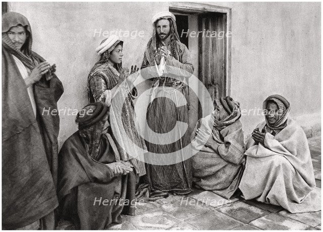 A mullah teaching a prayer to a young man, Iraq, 1925.Artist: A Kerim