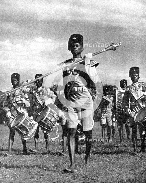 Bandsmen of the Northern Rhodesia Regiment beat a military tattoo, Zimbabwe, Africa, 1936.Artist: LNA Images