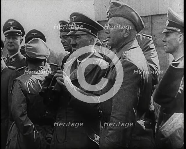 Adolf Hitler Holding a Pair of Binoculars and Standing With a Group of German Military Officers,1939 Creator: British Pathe Ltd.