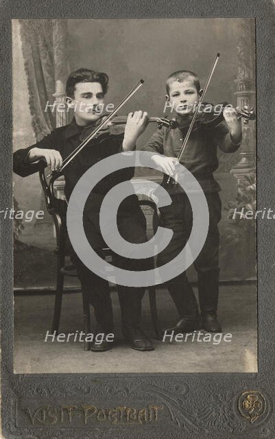 P.L. Stolyarov and V.P. Karetnikov playing violins, 1910-1919. Creator: I. F. Varlekhovskii.