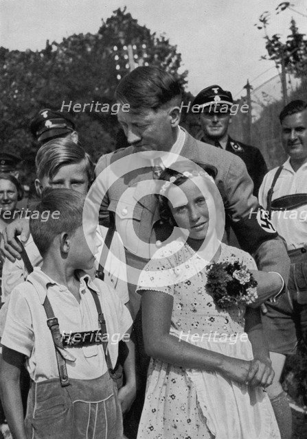 Adolf Hitler with a group of young children, 1936. Artist: Unknown