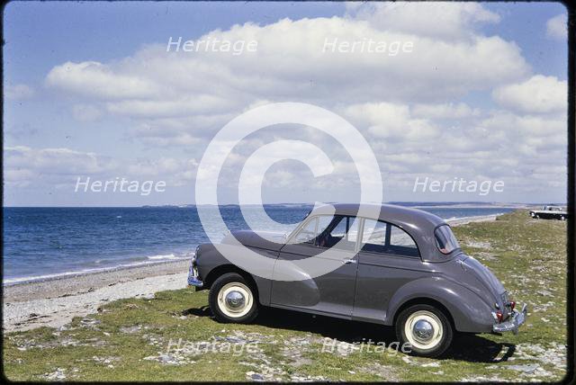 Morris Minor parked on the seafront, Traeth Llanddwyn, Anglesey, North Wales, 1962. Creator: Norman Barnard.