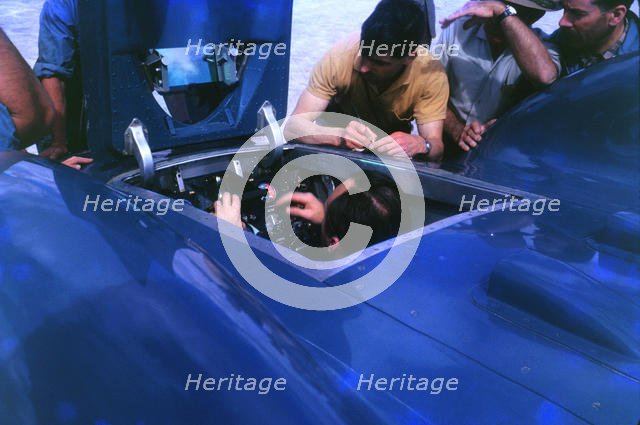 Donald Campbell in Bluebird CN7 cockpit at Lake Eyre 1963, Ken Norris on right. Creator: Unknown.