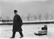 Skating Party - Unidentified Man Pulling Child On Sled, 1912. Creator: Harris & Ewing.