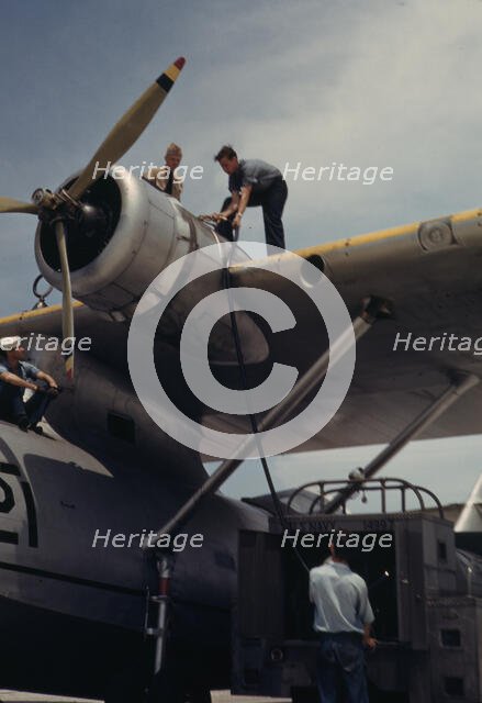 Fueling a plane at the Naval Air Base, Corpus Christi, Texas, 1942. Creator: Howard Hollem.