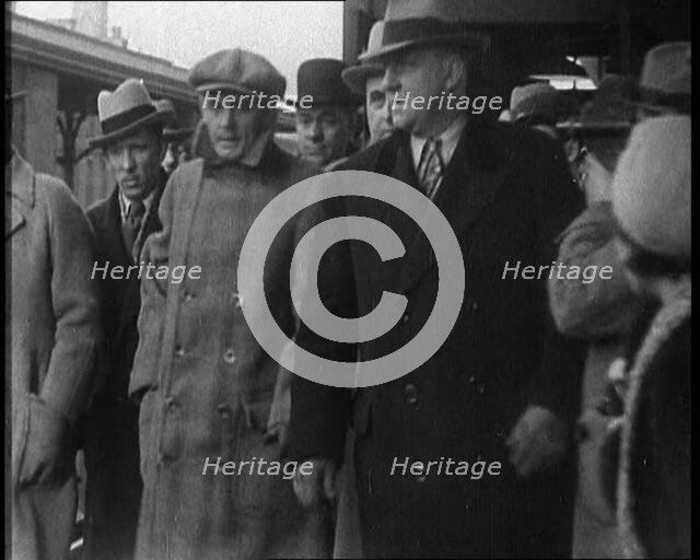 Alphonse Gabriel Capone AKA 'Al Capone' Being Escorted by a Group of Male American Civilians...1930. Creator: British Pathe Ltd.