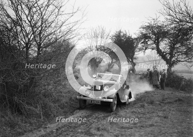 Lord Avebury's Ford V8 competing in the Sunbac Colmore Trial, Gloucestershire, 1934. Artist: Bill Brunell.