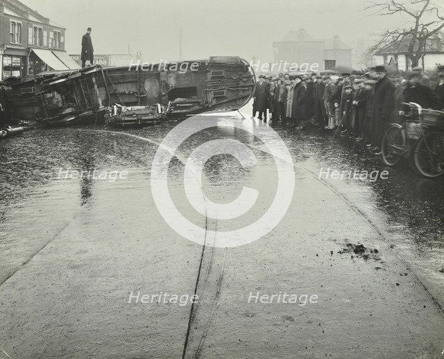 Overturned electric tram and onlookers, London, 1913. Artist: Unknown.