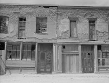 Crumbling buildings in Tombstone, Arizona, once a thriving mining town, 1937. Creator: Dorothea Lange.