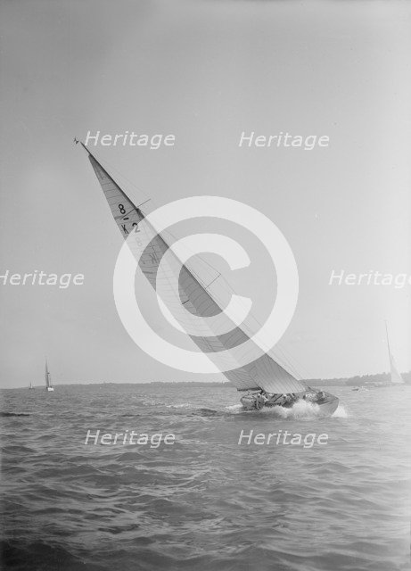 The 8 Metre class sailing yacht 'Carron' (K2), heeling upwind in a good breeze, 1934. Creator: Kirk & Sons of Cowes.