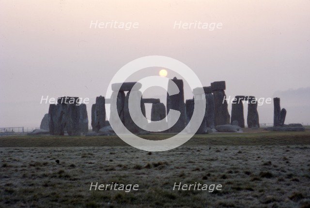 Dawn at Stonehenge, Wiltshire, c20th century. Artist: CM Dixon.