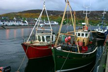 Fishing boats in Ullapool harbour at night, Highland, Scotland.