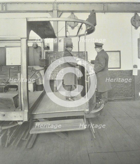 Learner-driver under instruction in a mock-up of tram car cab, London, 1932. Artist: Unknown.