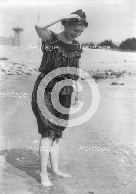 Frances Benjamin Johnston, standing in surf in wet bathing suit, n.d.. Creator: Frances Benjamin Johnston.