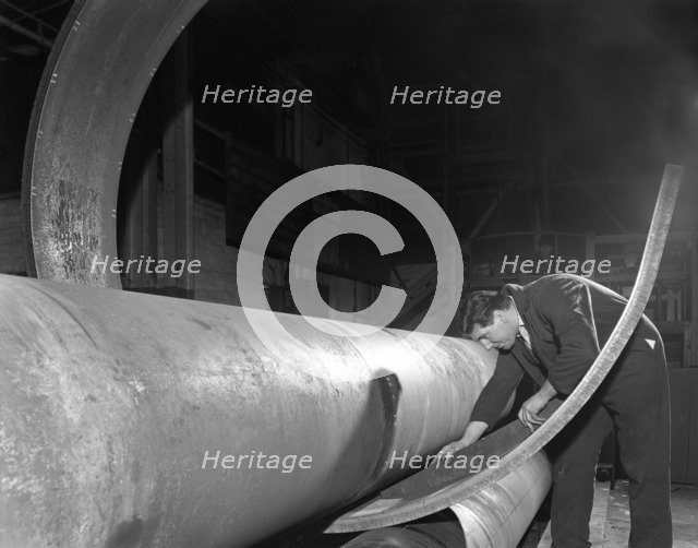 Checking the curve of a steel plate, Edgar Allen's steel foundry, Sheffield, Yorkshire, 1964.  Artist: Michael Walters