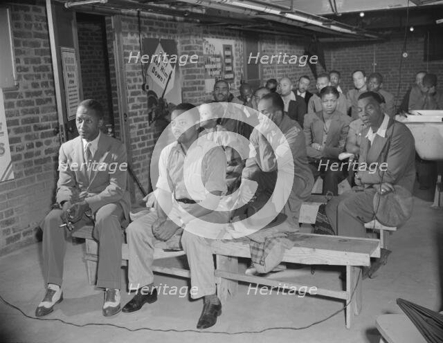 Possibly: Air raid wardens' meeting in zone nine, Southwest area, Washington, D.C., 1942. Creator: Gordon Parks.
