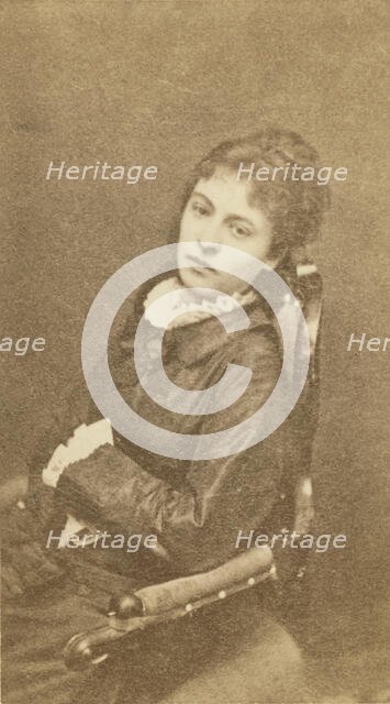 Three-quarter length portrait of woman, seated in chair, facing left, between 1880 and 1886. Creator: Unknown.