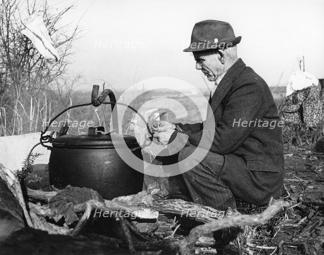 Gypsy man with cauldron, 1960s.