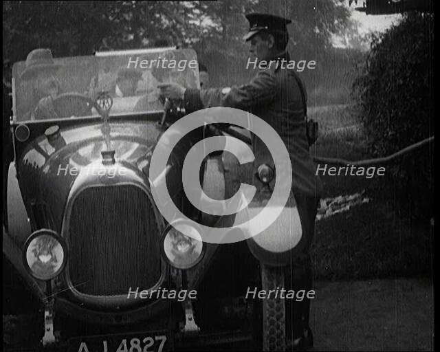 A British Automobile Association Employee Filling a Car With Petrol at a Petrol Station, 1920. Creator: British Pathe Ltd.