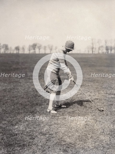 A lady golfer playing at Falsterbo Colf Club, Sweden. Artist: Otto Ohm
