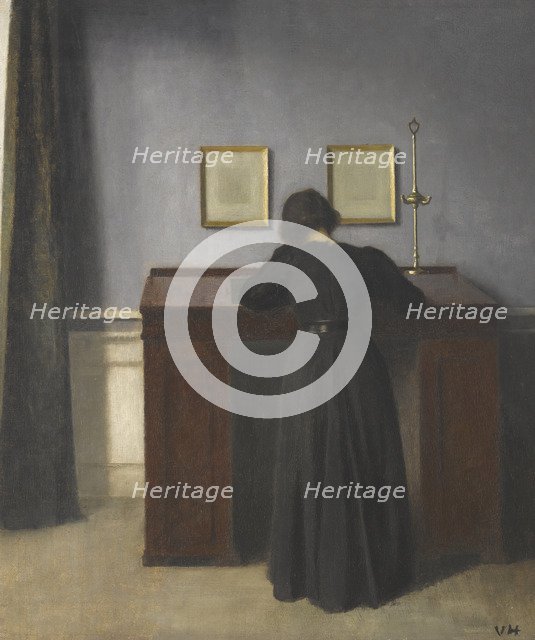 Ida Standing at a Desk. Artist: Hammershøi, Vilhelm (1864-1916)