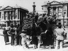 French street sellers offering souvenirs to a truckload of German soldiers, Paris, 27 July 1940. Artist: Unknown