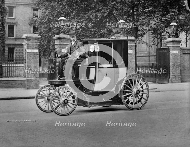 A motor cab and driver, London, c1900. Artist: York & Son