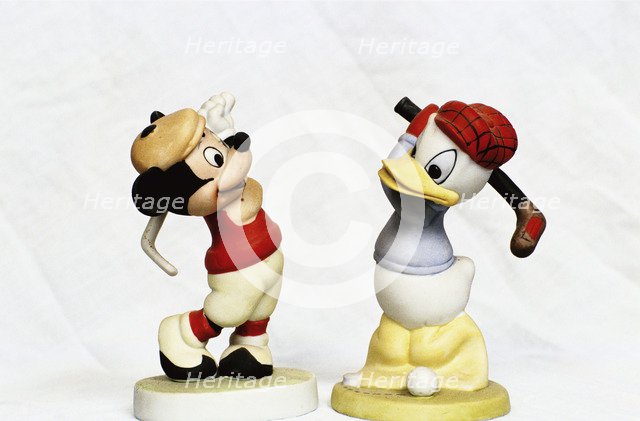 Hand-painted golfing figures of Mickey Mouse and Donald Duck, c1930s. Artist: Unknown