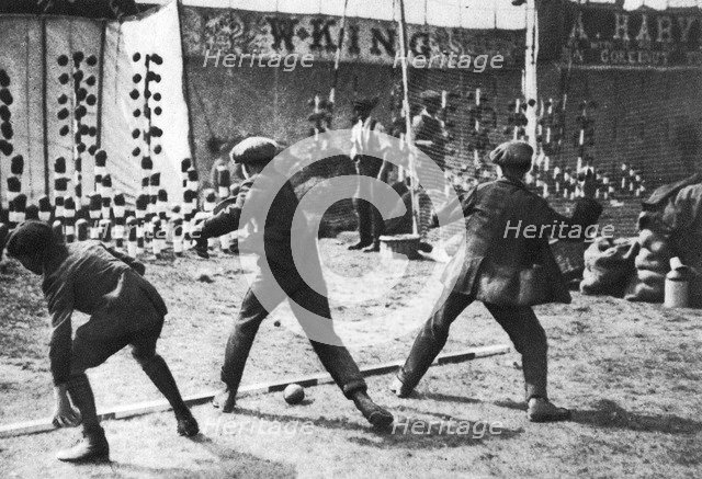 A coconut shy during a bank holiday on Blackheath Common, London, 1926-1927.Artist: Hall
