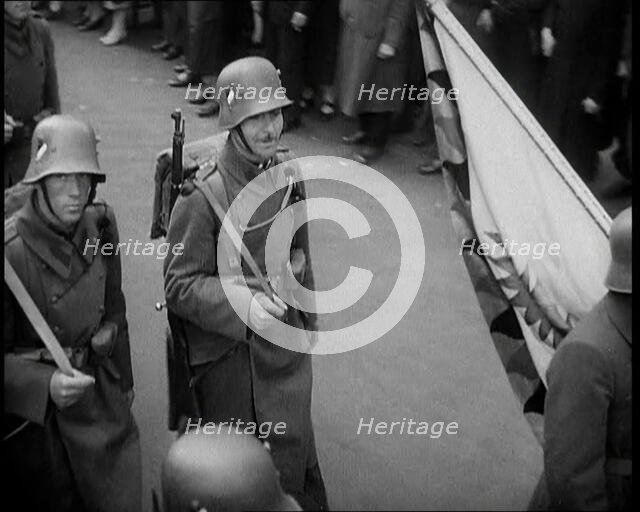 German Soldiers Marching Down a Street as a Crowd Watches, 1930s. Creator: British Pathe Ltd.
