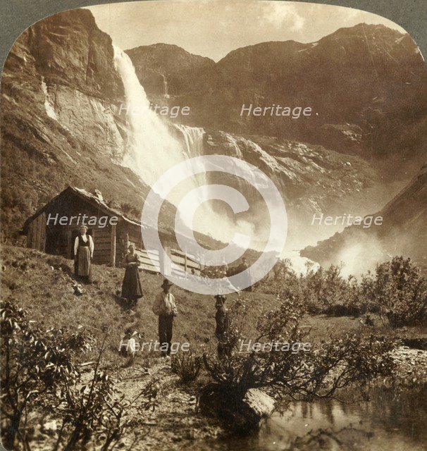'Humble mountain home at the foot of cliffs where Skiaeggedals Falls leap 525 ft., Norrway', c1905. Creator: Unknown.