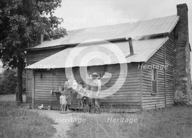 Tobacco sharecropper and his family at the back..., Person County, North Carolina, 1939. Creator: Dorothea Lange.