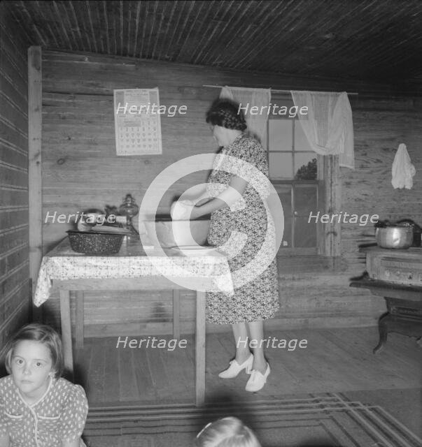Wife of tobacco sharecropper in kitchen of home, Person County, North Carolina, 1939. Creator: Dorothea Lange.