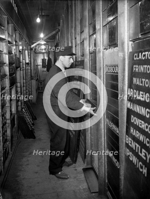 Member of staff changing departure information, Liverpool Street Station, London, 1950. Artist: Unknown