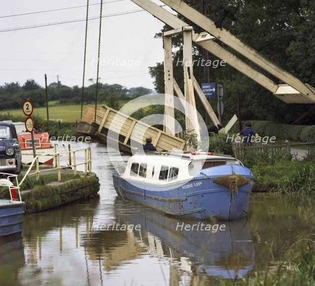 A canal boat passing under a lift bridge on the Llangollen Canal, 1970. Artist: Michael Walters