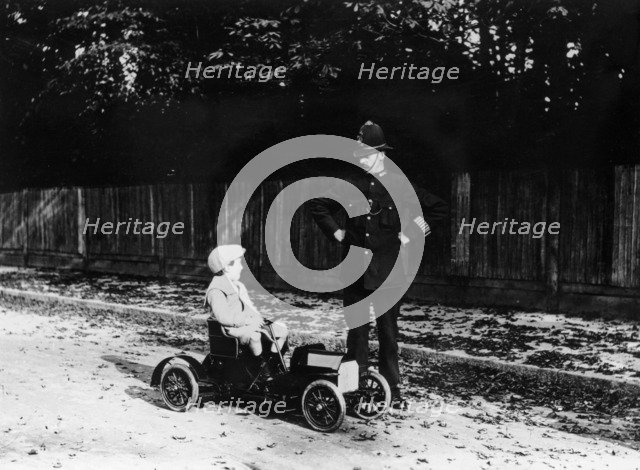 Boy in 1908 Mercedes pedal car. Artist: Unknown
