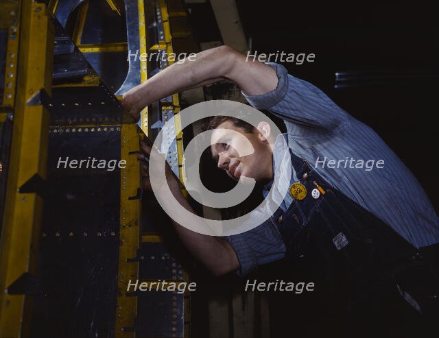 A wing brace assembly for a B-25 bomber is prepared...North American Aviation, Inc., Calif., 1942. Creator: Alfred T Palmer.