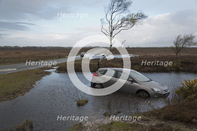 Ford Focus in flooded ditch after losing control on wet road 2012 Artist: Unknown.