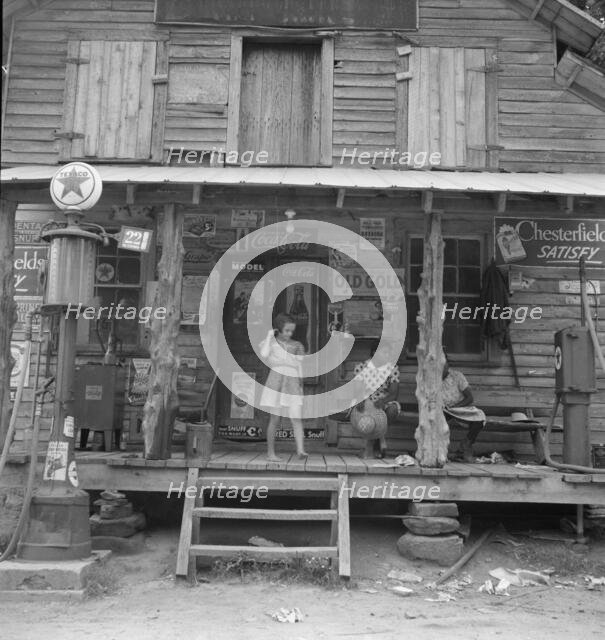 Daughter of white tobacco sharecropper at country store, Person County, North Carolina, 1939. Creator: Dorothea Lange.