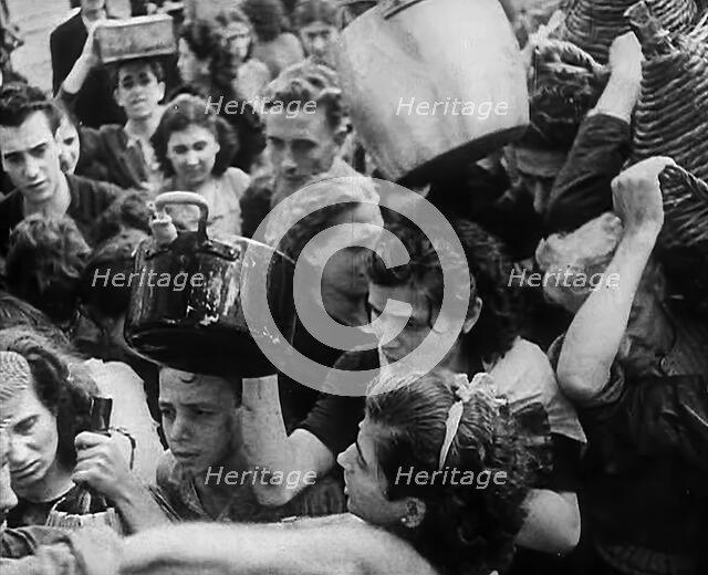Italian Civilians Gathering Water in Naples, 1943-1944. Creator: British Pathe Ltd.