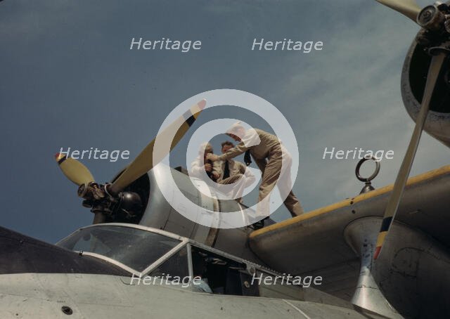 Working on a plane at the Naval Air Base, Corpus Christi, Texas, 1942. Creator: Howard Hollem.