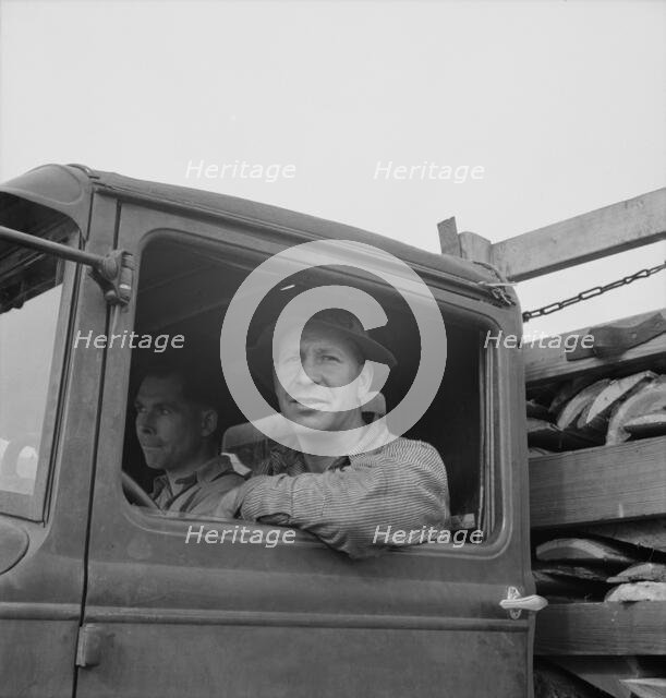 Stump farmer hauling load of slab wood for sale in town, Bonner County, Idaho, 1939. Creator: Dorothea Lange.