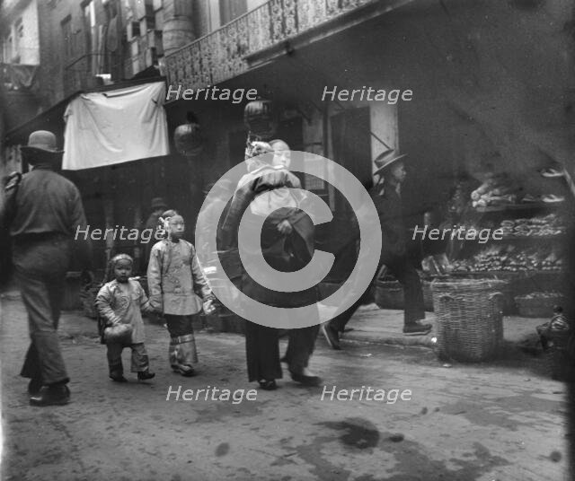 Woman and children walking down a street, Chinatown, San Francisco, between 1896 and 1906. Creator: Arnold Genthe.