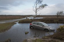 Ford Focus in flooded ditch after losing control on wet road 2012 Artist: Unknown.